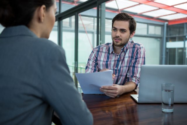Business executive conducting job interview with woman