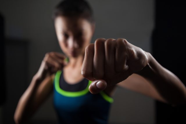 Woman practicing boxing in fitness studio