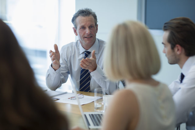 Corporate businessman talking in conference room meeting