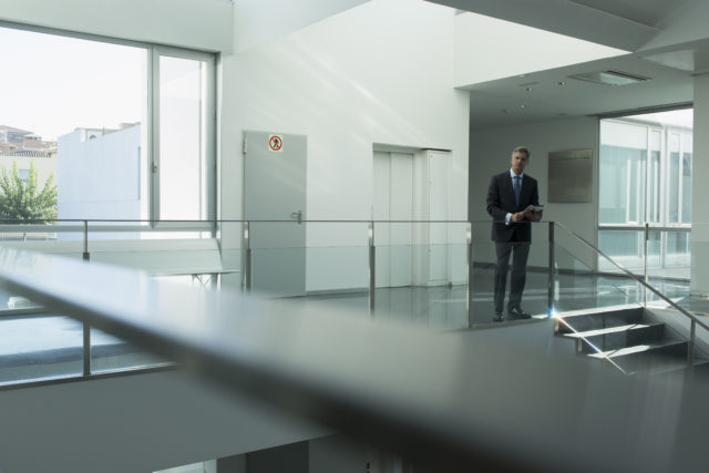 Portrait confident businessman in office corridor